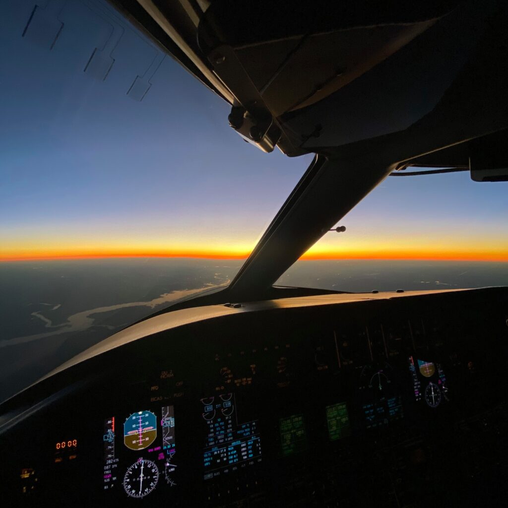 A view of the sunset from inside an airplane.