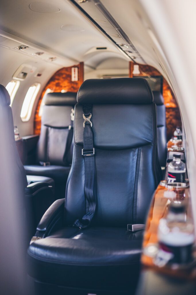A black leather chair in the middle of an airplane.