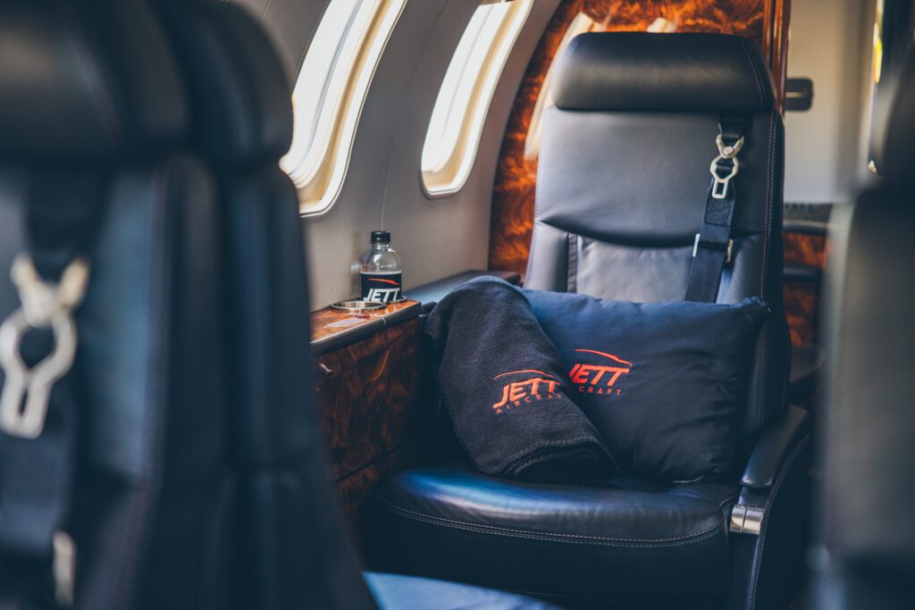 A jet seat with pillows on it.